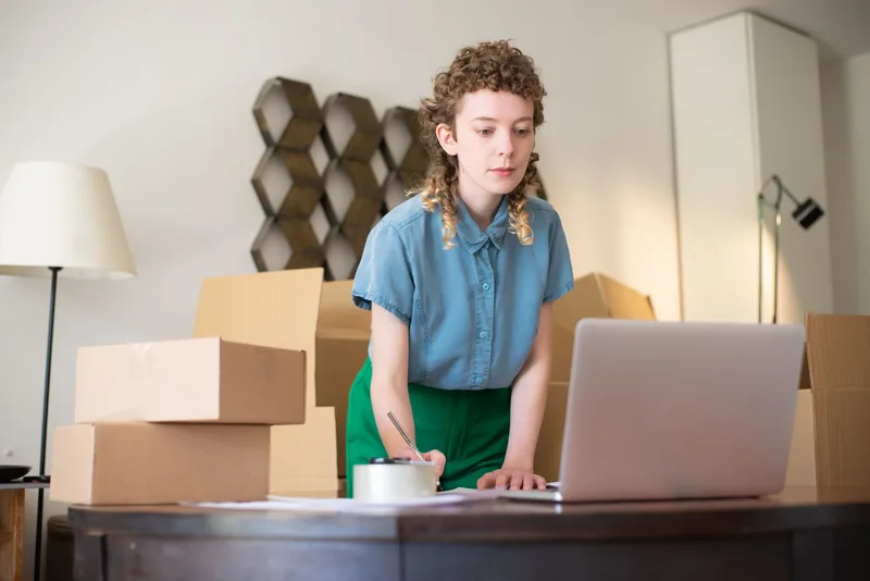 Seller managing ecommerce inventory across multiple marketplaces from a single laptop