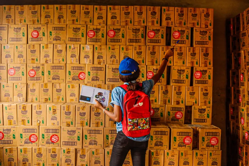 Warehouse staff counting and recording stock levels to set accurate reorder points