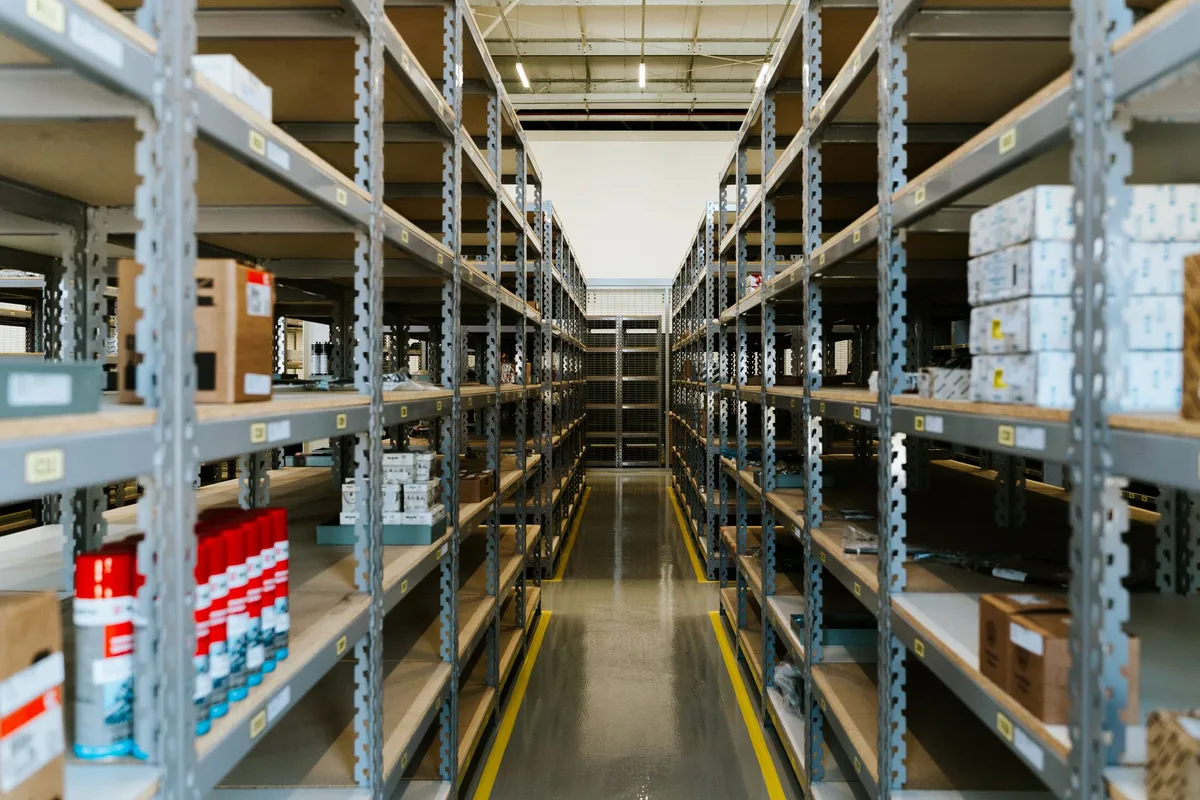 Organized warehouse with metal shelving and stored merchandise for ecommerce inventory planning