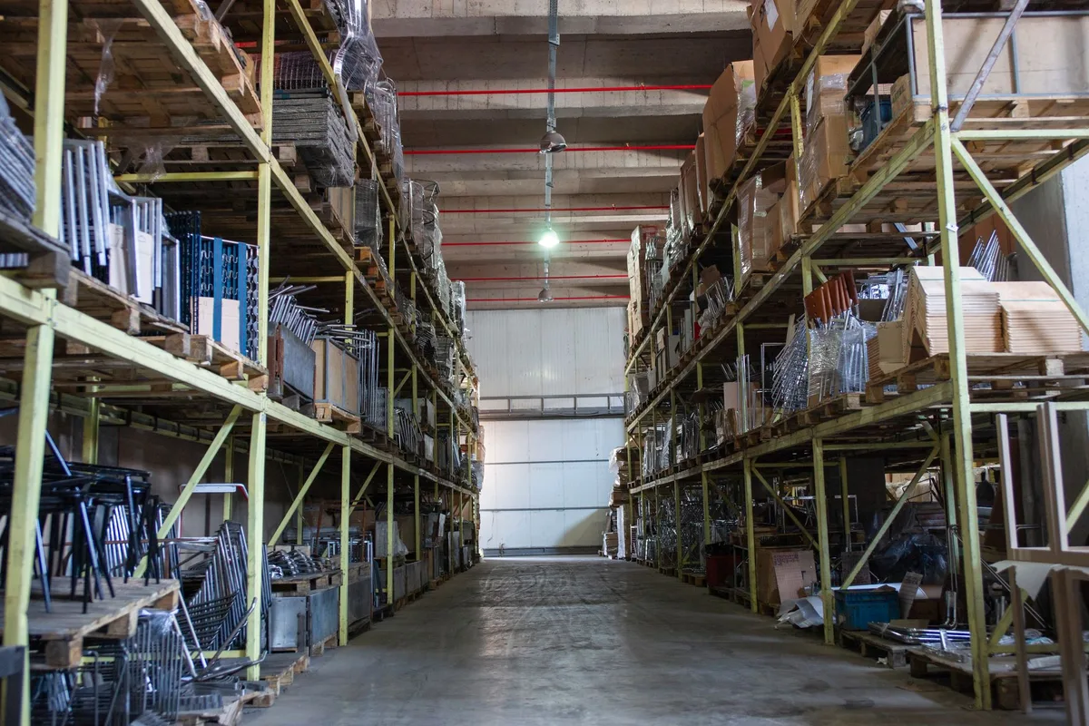 Wide aisle in a warehouse lined with industrial metal pallet racking
