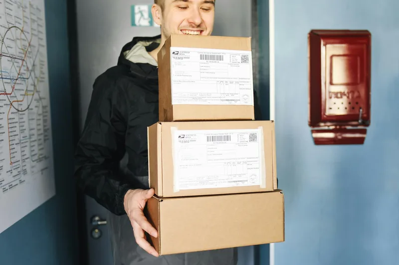 Delivery worker managing packages representing multi-channel ecommerce order fulfillment across Shopee MY, Lazada MY, and TikTok Shop