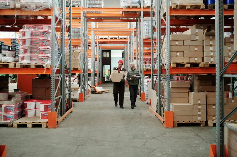 Workers handling packages in a spacious fulfillment warehouse
